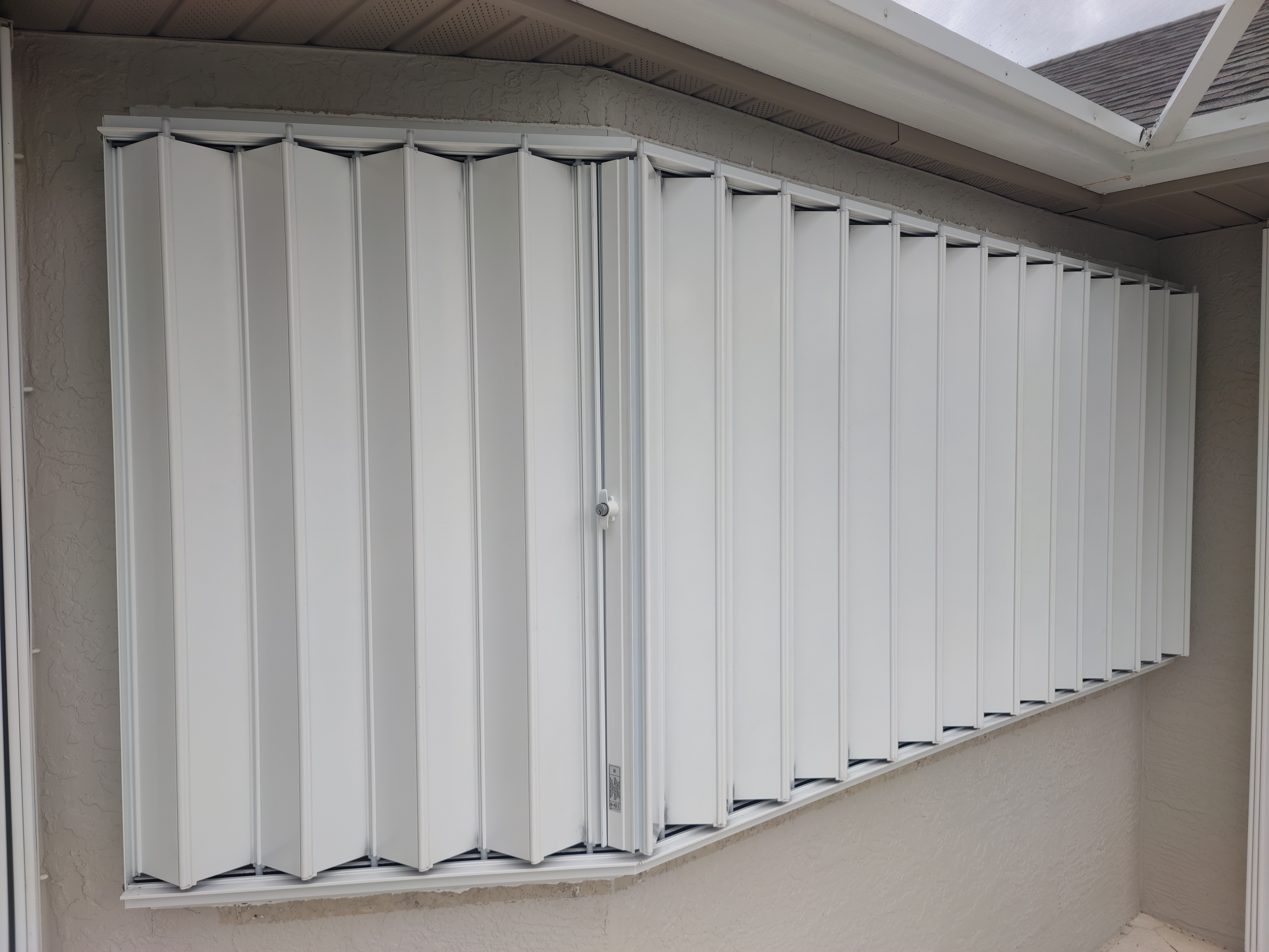 Accordion hurricane shutter fully closed and locked on a Sarasota home