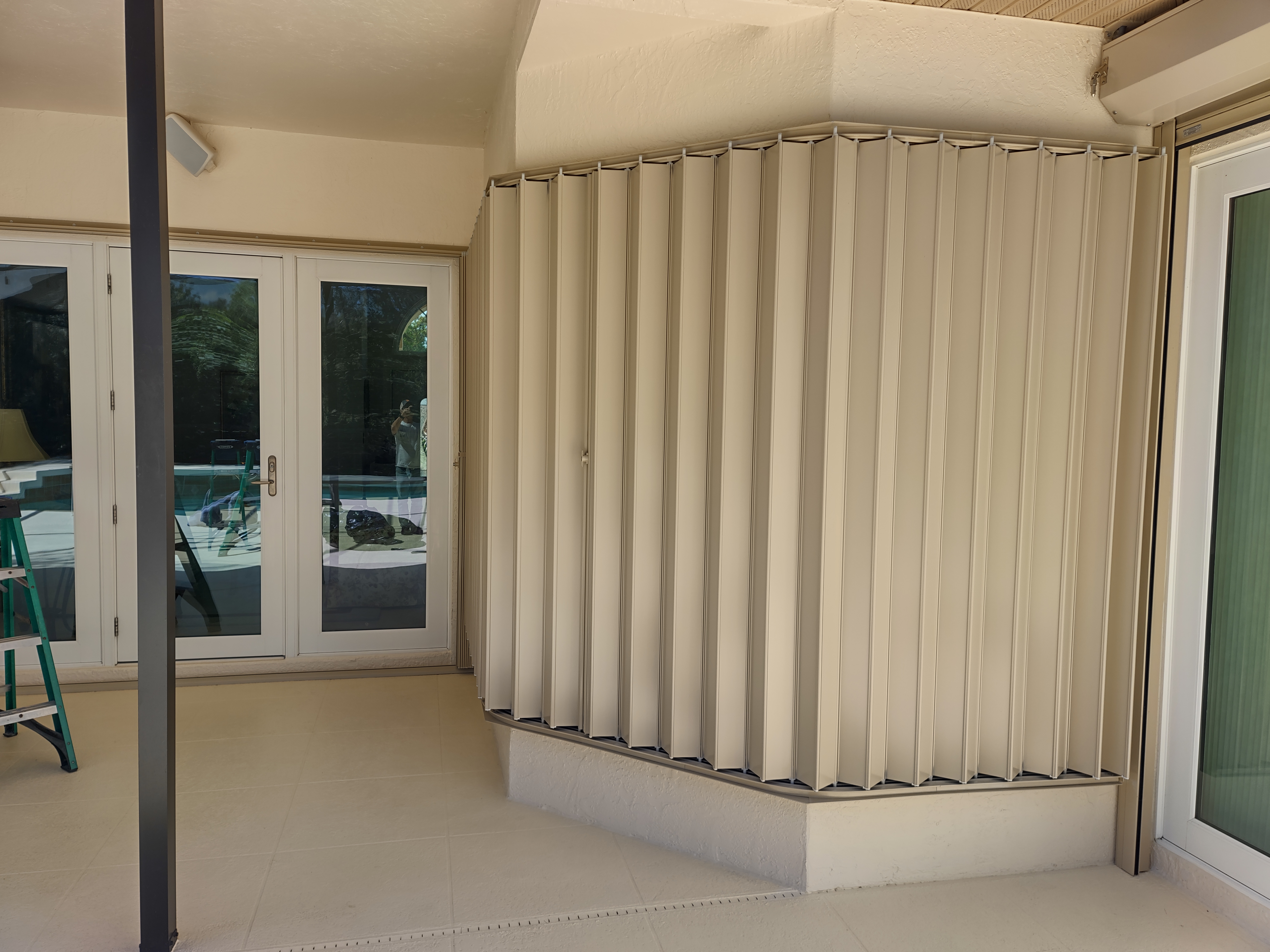 Accordion hurricane shutters closed on a Sarasota home's bay window