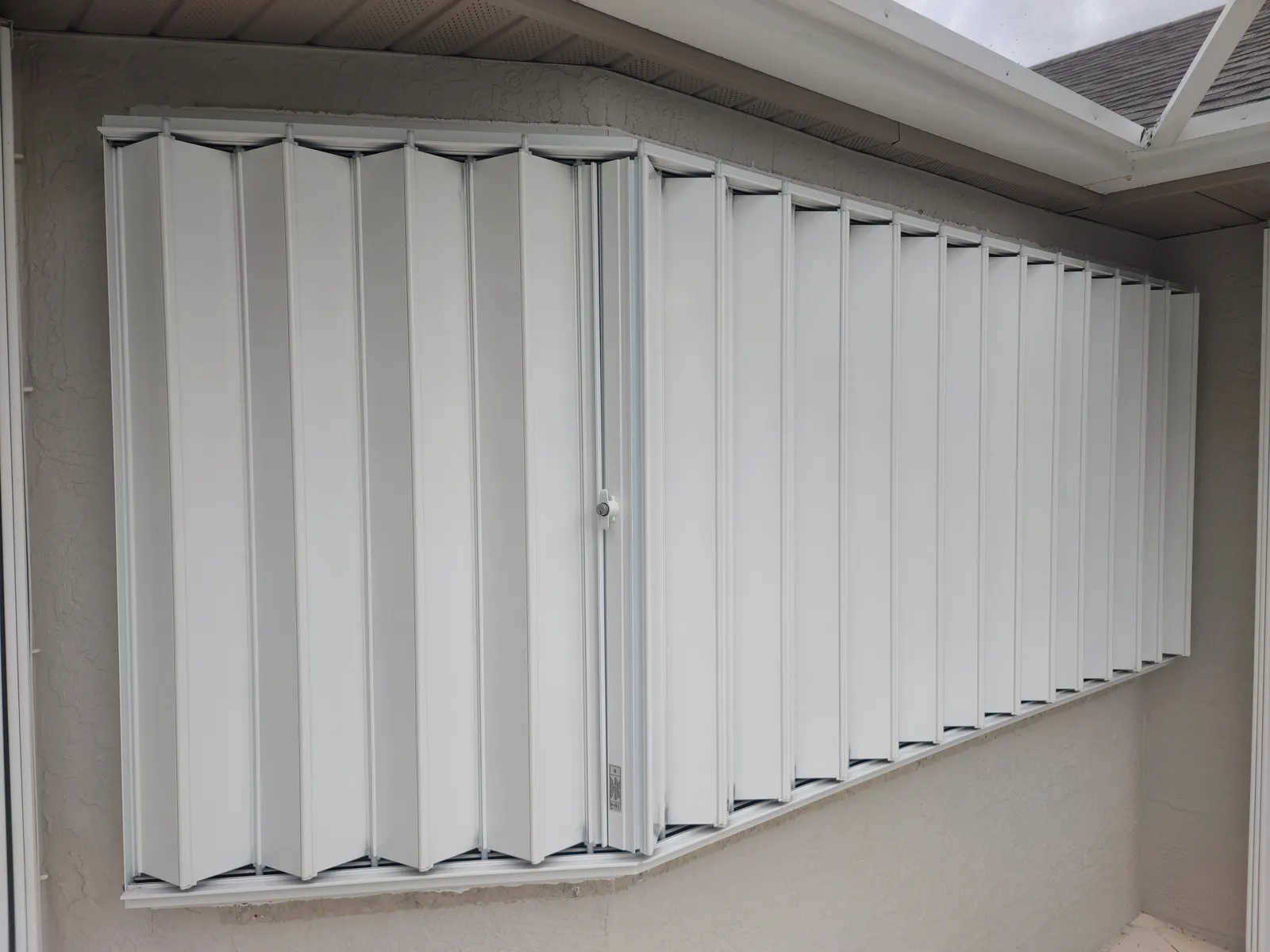 Accordion hurricane shutter fully closed and locked on a Sarasota home